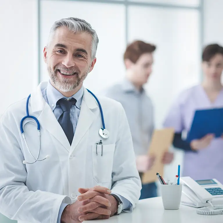 Smiling doctor representing medical and healthcare financial expertise.