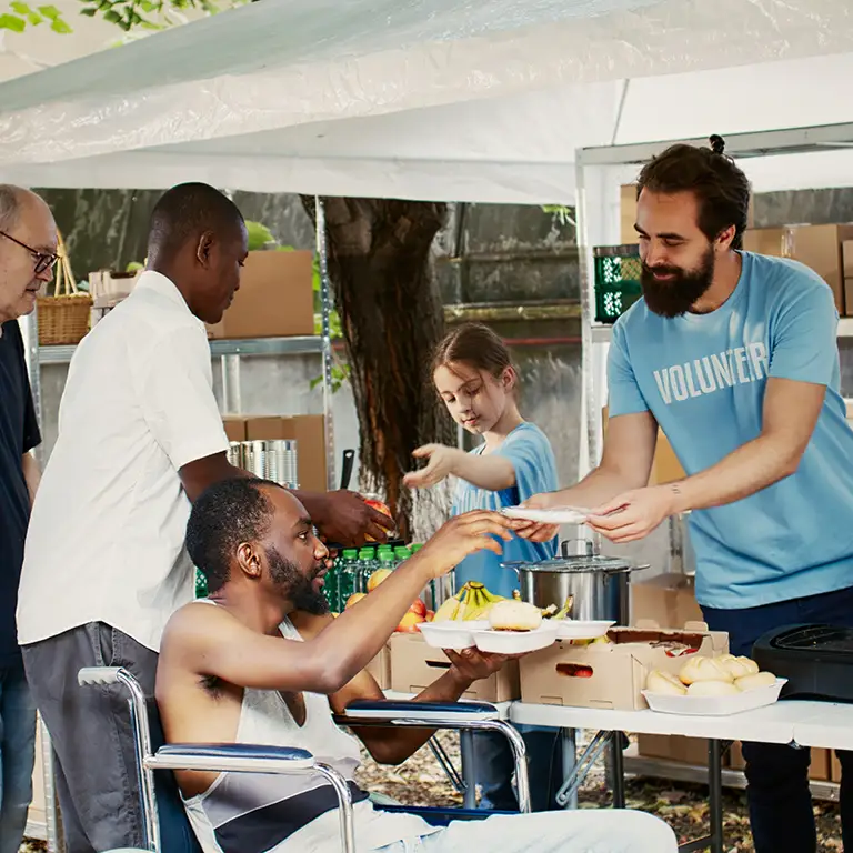 Volunteers serving food representing financial services for nonprofits and NGOs.