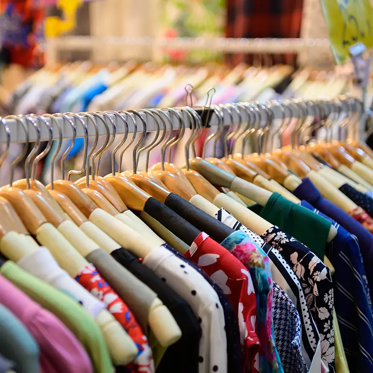 Row of colorful shirts on hangers representing retail and e-commerce financial services.
